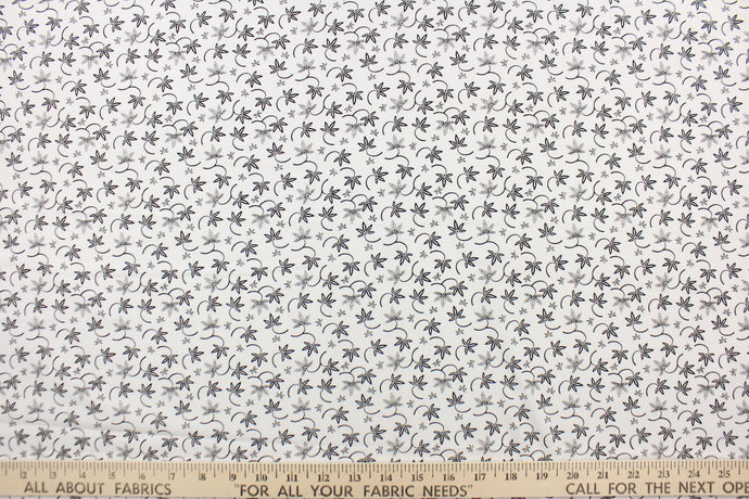This fabric features a  floral design in black set against a white background. 