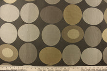 Load image into Gallery viewer, Geometric pattern of circles and ovals in gold and pewter tones on a brown gray background
