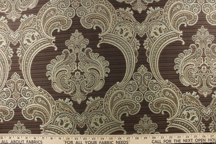 ornamental damask design in light blue and hints of copper  tones on a dark brown  background