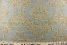 Load image into Gallery viewer, ornamental damask design in light beige and hints of light gold tones on a light blue background
