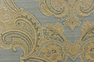 Ornamental damask design in light beige and hints of light gold tones on a light blue background.