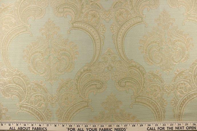 ornamental damask design in light beige and hints of light gold tones on a light green background