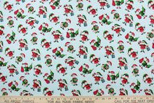 Load image into Gallery viewer,  This quilting print features a Christmas design of elves in blue, white, red, green, brown, black and golden yellow set against a pale blue background.
