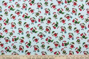 This quilting print features a Christmas design of elves in blue, white, red, green, brown, black and golden yellow set against a pale blue background.