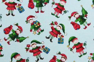  This quilting print features a Christmas design of elves in blue, white, red, green, brown, black and golden yellow set against a pale blue background.