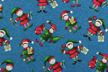 Load image into Gallery viewer,  This quilting print features a Christmas design of elves in pale blue, white, red, green, brown, black and golden yellow set against a dark blue background. 
