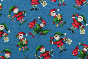 This quilting print features a Christmas design of elves in pale blue, white, red, green, brown, black and golden yellow set against a dark blue background. 