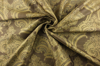 Carlisle is a jacquard fabric with a ornamental damask design in green and gray and light gold on a golden brown background.