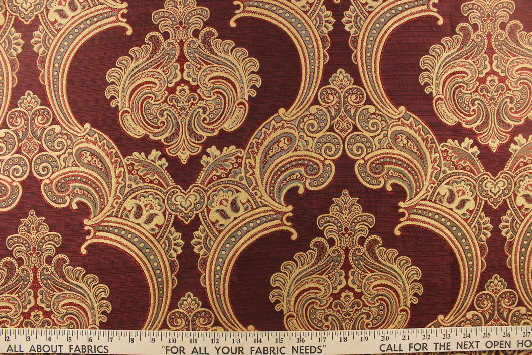 ornamental damask design in gray and  gold on a deep red background