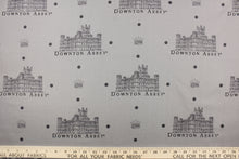 Load image into Gallery viewer,  Featuring the Downton Abbey building and wording in gray and black with dark gray dots against a gray background. 
