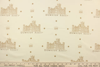  Featuring the Downton Abbey building and wording in beige and brown with brown dots against a pale beige background.  