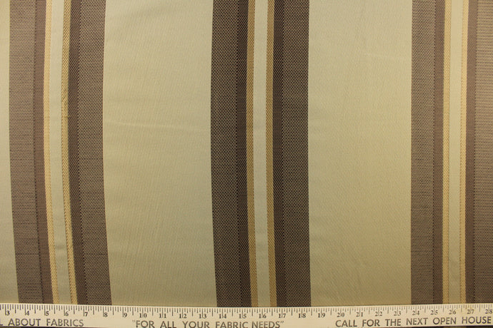 Striped pattern in shades of brown and  gold on a  dark  beige background
