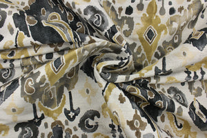 This jacquard fabric features an Aztec design in  gold, black, gray, and brown set against a off white. 