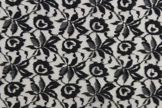 This lace features a woven floral design in black .
