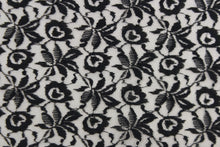 Load image into Gallery viewer, This lace features a woven floral design in black .
