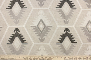 This tapestry features embroidered Aztec design in sliver, white, gray, and dark brown black set against a natural background . 