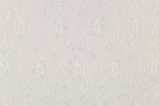 This lace features a woven floral design in off white with iridescent sparkle.