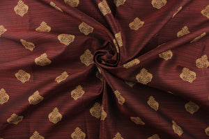 Ornamental damask medallion with hints of gold on a dark or deep red background