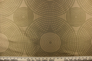 Geometric multi-layer, circular pattern in tone on tone colors in taupe, beige, khaki, brown and gold tones.