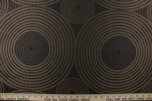 Geometric multi-layer, circular pattern in tone on tone colors in black, dark brown and dark gold tones.