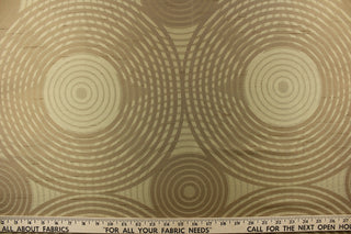 Geometric multi-layer, circular pattern in tone on tone colors in beige, khaki, brown and  gold tones.