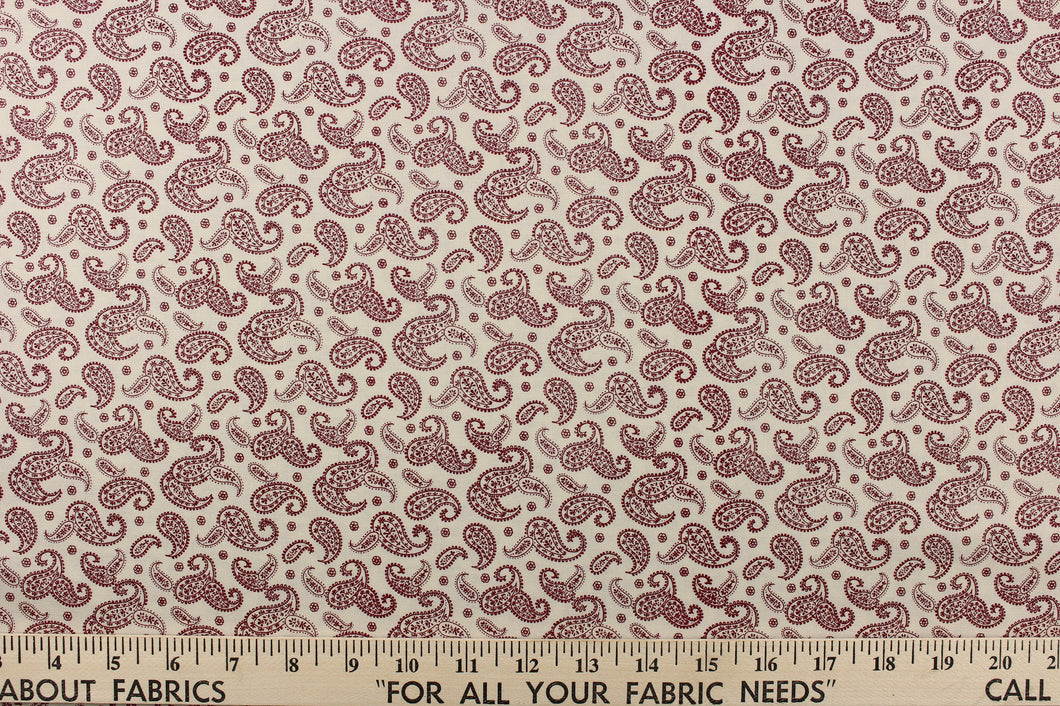   A fun paisley design in basic colors of  red set against a cream background.