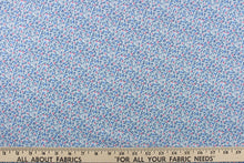 Load image into Gallery viewer,  This fabric features a dainty floral design in pale blue  with pink , blue and white flowers . 
