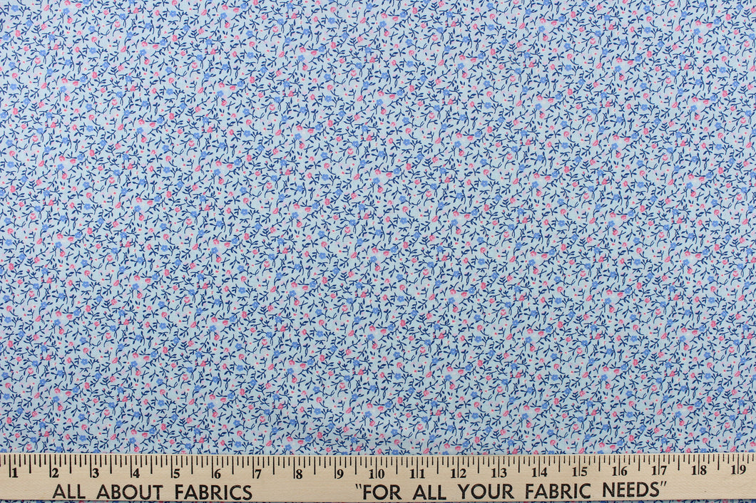  This fabric features a dainty floral design in pale blue  with pink , blue and white flowers . 