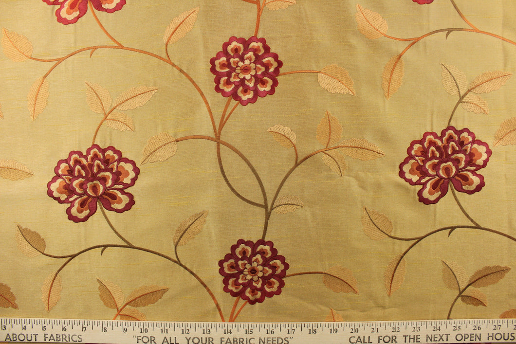  This stunning fabric features a embroider  flower in red and orange on a gold background. 