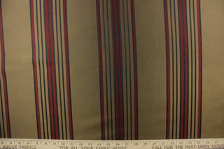  This fabric features a striped design in brown and burgundy colors on a dark gold background. 