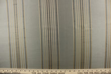 Load image into Gallery viewer, This fabric features a striped design in gold on a pale gray blue background
