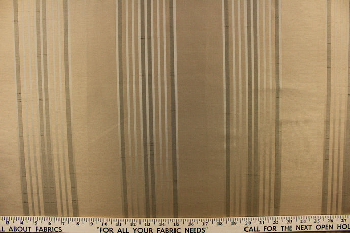 This fabric features a striped design in gold on a gold  background. 