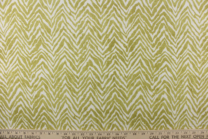 This fabric features a chevron tiger stripe in lime green  against a white background.