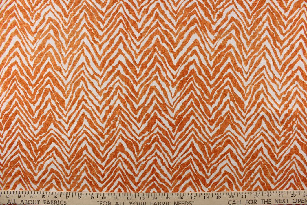 This fabric features a chevron tiger stripe in orange against a white background. 