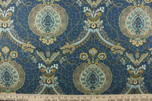 Load image into Gallery viewer, This unique fabric feature a medallion in gold tones, gray, cream and blue against a blue cheetah print. 
