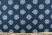 Load image into Gallery viewer,  This fabric features a geometric design of circles in white on a blue background. 
