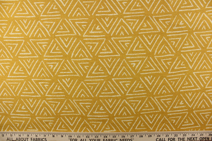 This bright fabric features a geometric design of white triangles against a canary yellow background. 