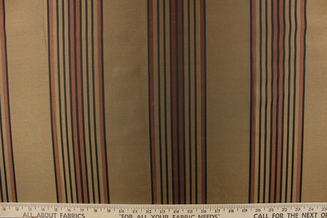 This fabric features a striped design in brown, black and gold on a bronze  background. 