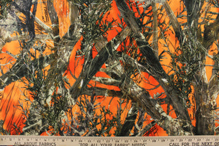: This outdoor canvas features a realistic maximum concealment camouflage design against a orange background.