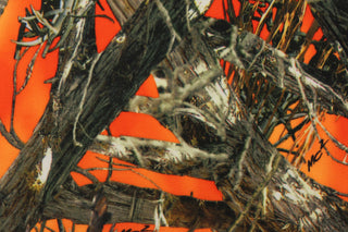 : This outdoor canvas features a realistic maximum concealment camouflage design against a orange background.