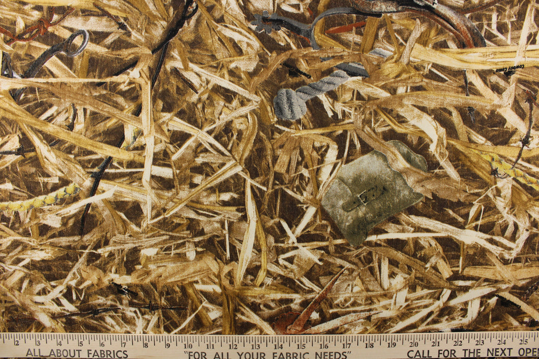  This fabric features a straw camouflage design in brown tones with items within the straw. 