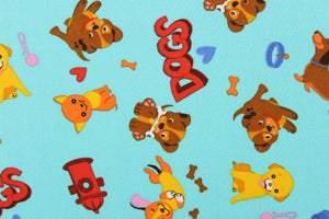 This fabric features a cute canine design with different dogs, dog toys, dog houses in pink, orange, yellow, brown, red, white and blue against a aqua blue background. 