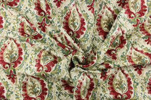 This fabric features a damask design in green, teal, cherry red, brown, beige, and cream. 
