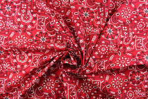 This cute and soft cotton paisley print bandana fabric features geometrical shapes with floral accents in red, white and black. 