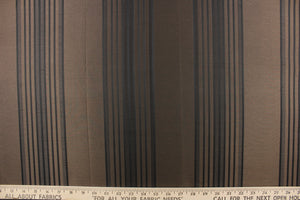  This fabric features a striped design in black on a brown background. 