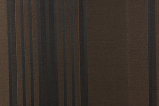  This fabric features a striped design in black on a brown background. 