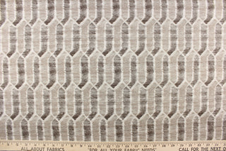 This fabric features a geometric design in brown and beige tones and white with hints of gray. 