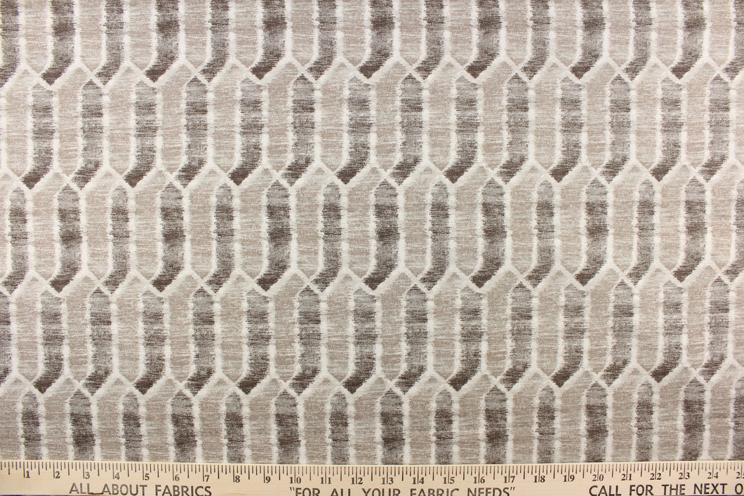 This fabric features a geometric design in brown and beige tones and white with hints of gray. 