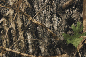This outdoor canvas features a realistic maximum concealment camouflage design in green, brown and black.