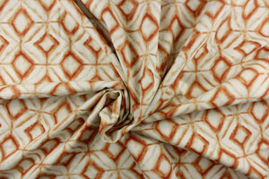 This fabric features a geometric design of diamonds in shades of orange with light khaki shading on a off white background. 